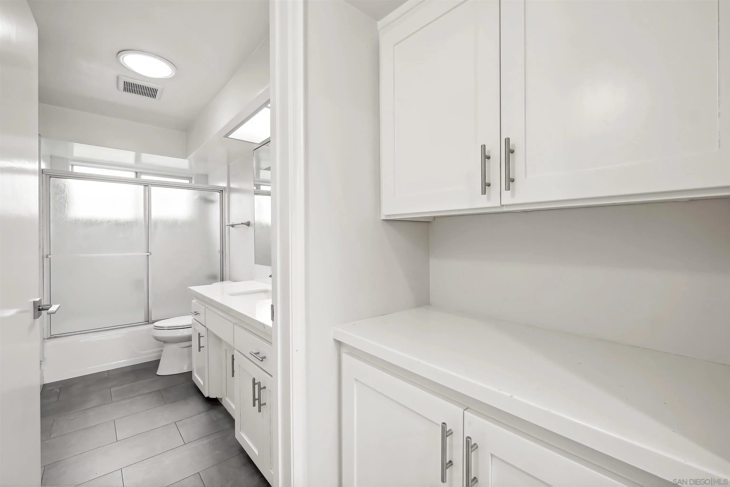 838 Lamplight Drive La Jolla, CA 92037 - Photo 33 of 42 a bathroom with a sink a toilet and a shower