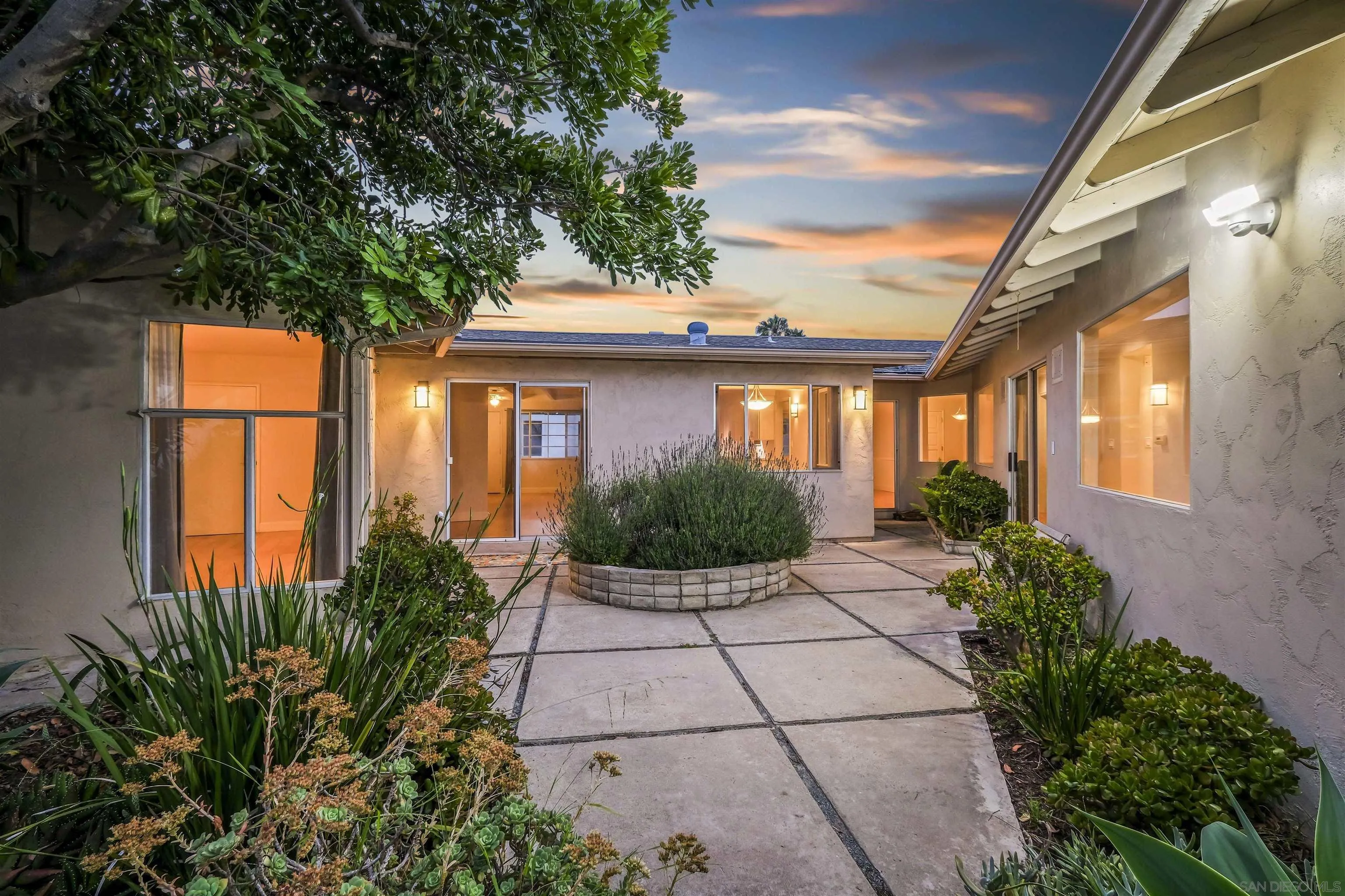 838 Lamplight Drive La Jolla, CA 92037 - Photo 8 of 42 a front view of a house with a garden