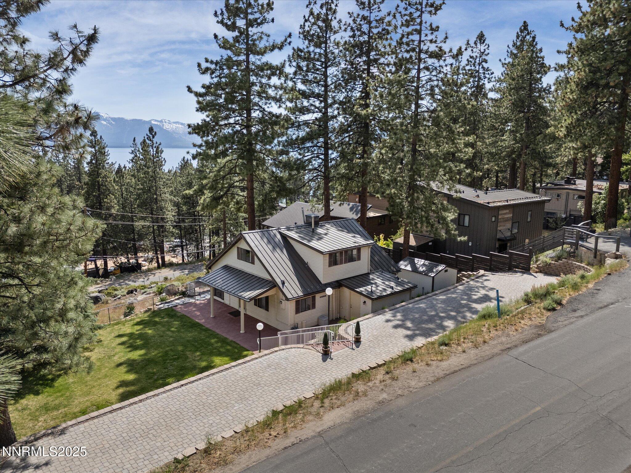 an aerial view of a house with backyard space and sitting area