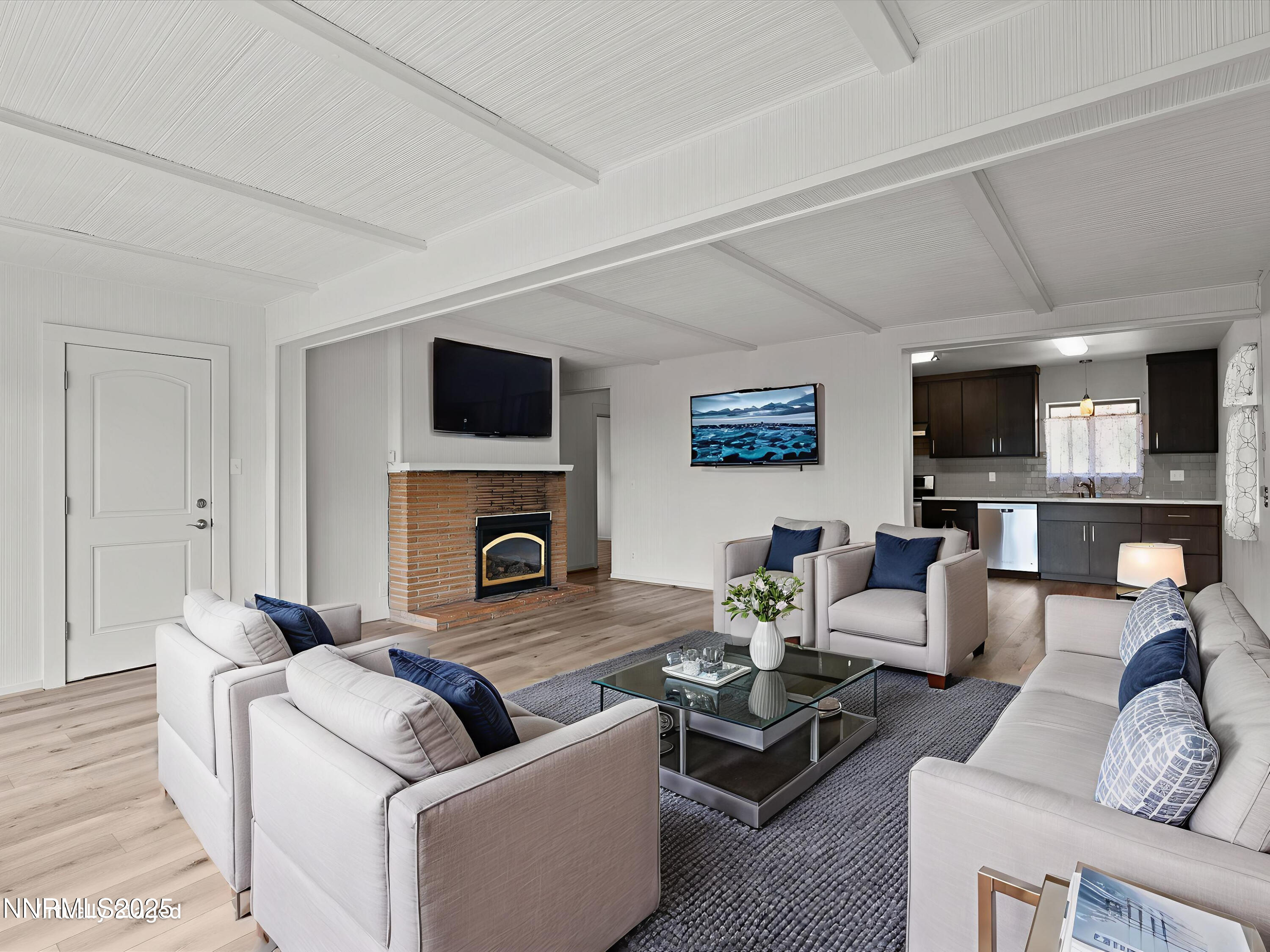 605 Jerry Drive Zephyr Cove, NV 89448 - Photo 12 of 61 a living room with furniture a fireplace and a flat screen tv