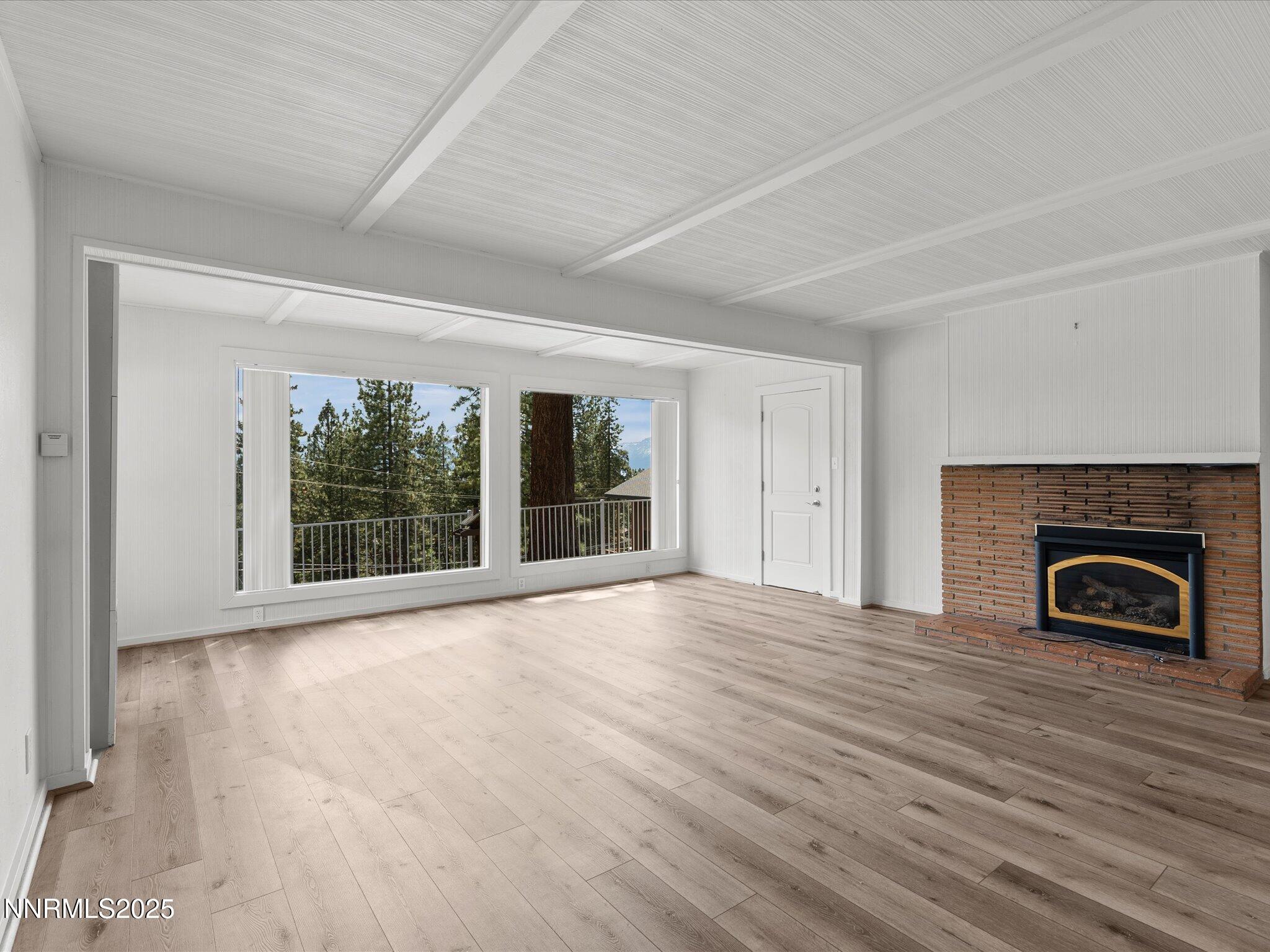 605 Jerry Drive Zephyr Cove, NV 89448 - Photo 13 of 61 wooden floor fireplace and windows in an empty room