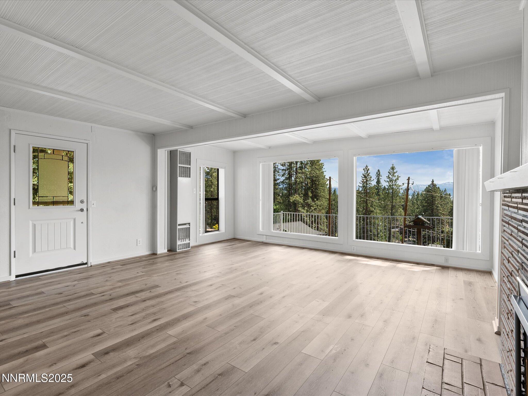 605 Jerry Drive Zephyr Cove, NV 89448 - Photo 15 of 61 a view of an empty room with wooden floor and a window
