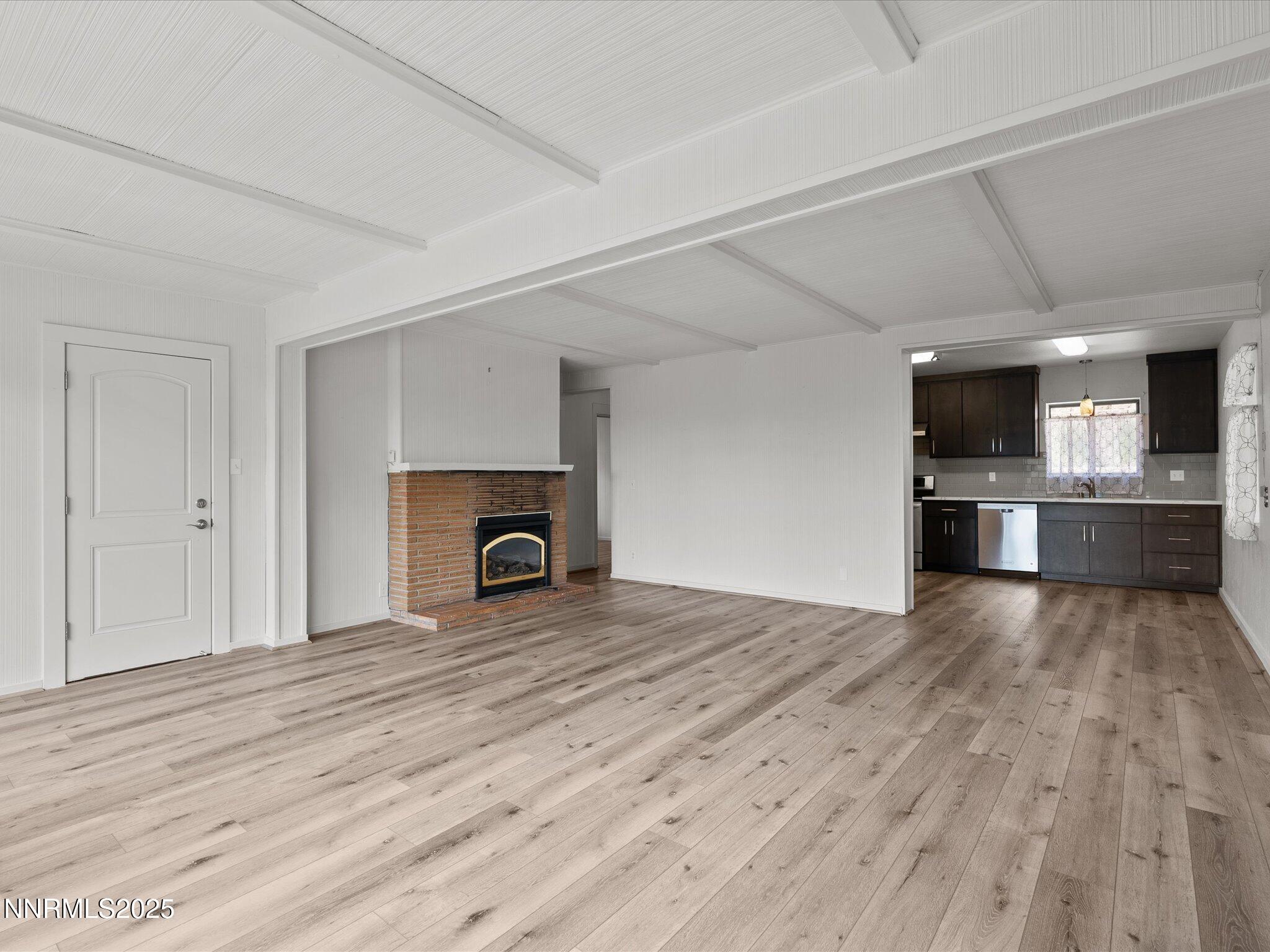 605 Jerry Drive Zephyr Cove, NV 89448 - Photo 16 of 61 a view of empty room with wooden floor and fireplace