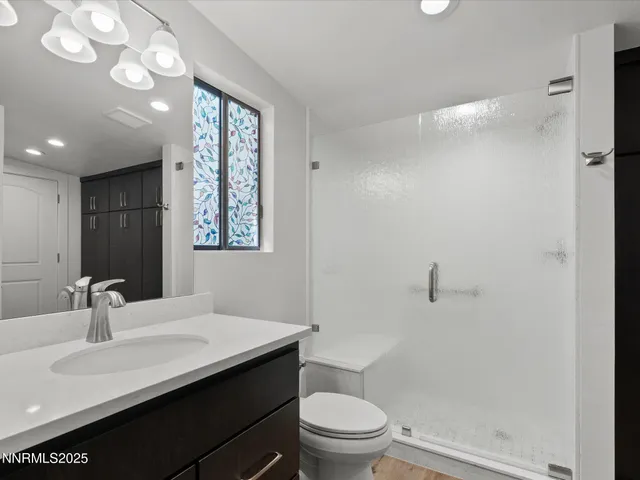 a bathroom with a sink toilet and a mirror