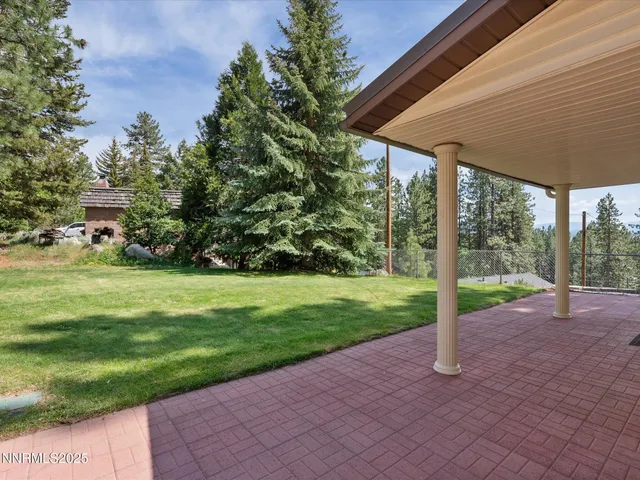 an empty room with wooden floor and window