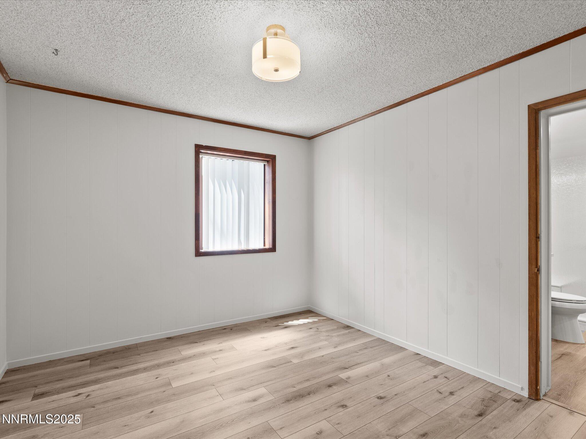 605 Jerry Drive Zephyr Cove, NV 89448 - Photo 29 of 61 an empty room with wooden floor and window