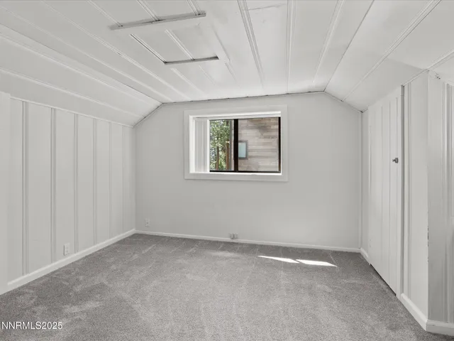 a view of swimming pool with outdoor seating and trees in the background