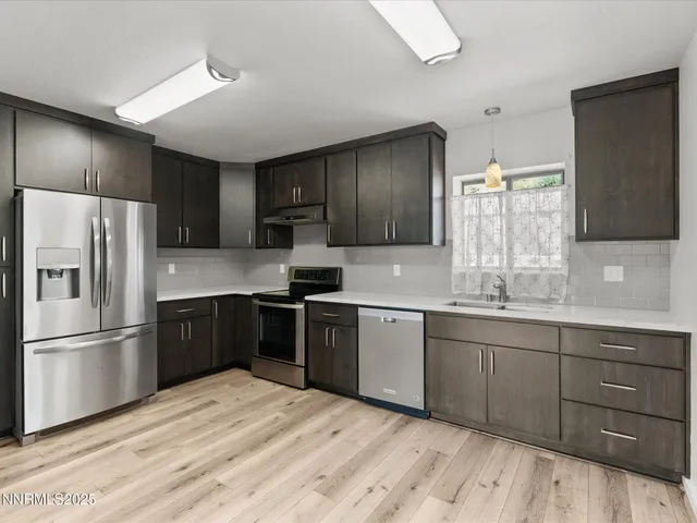 a kitchen with cabinets and appliances
