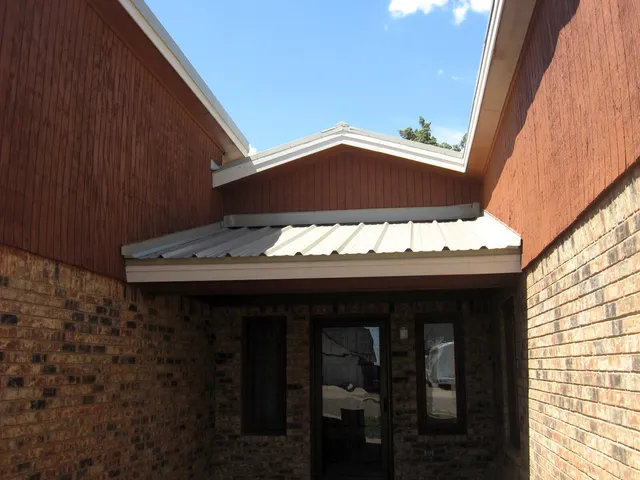 a view of a porch with a table and chair