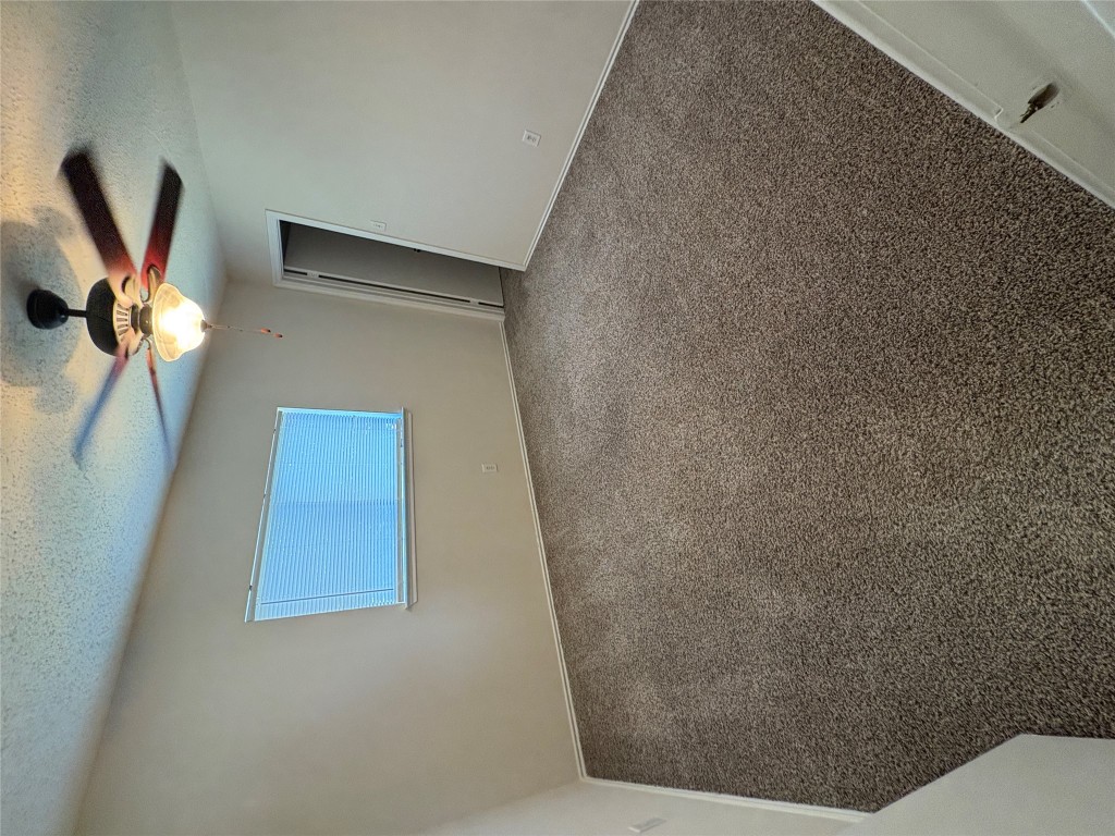 1367 Lakeside Loop Round Rock, TX 78665 - Photo 14 of 19 Spare room with a textured ceiling, carpet floors, and a ceiling fan