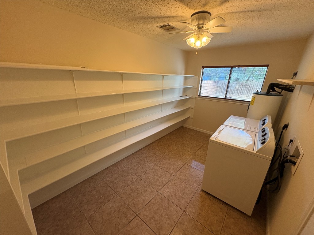 1367 Lakeside Loop Round Rock, TX 78665 - Photo 8 of 19 Storage room with washer and clothes dryer, ceiling fan, and electric water heater
