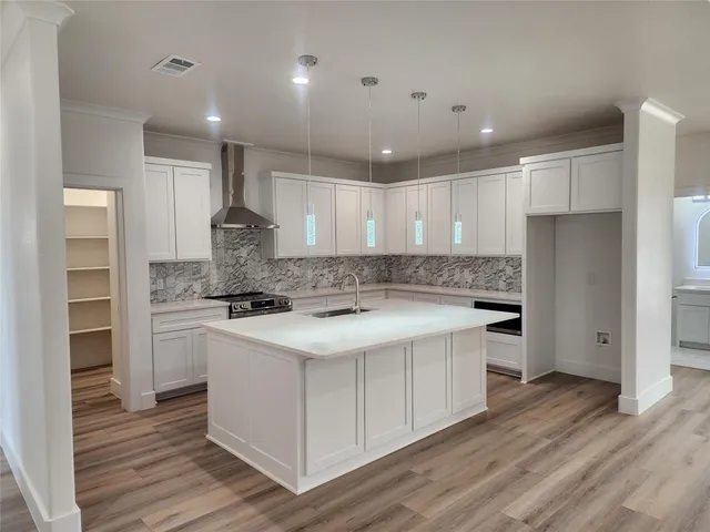 a kitchen with a sink stove and refrigerator