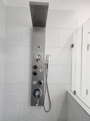 a bathroom with a shower and a window