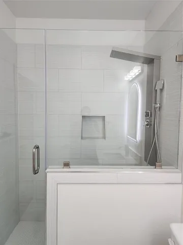 a bathroom with a bathtub and shower