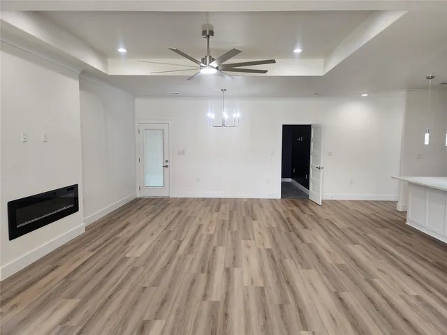 a view of an empty room and wooden floor