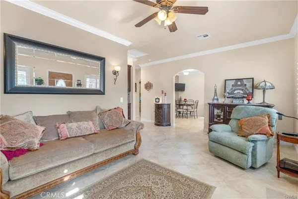 a living room with furniture and a chandelier