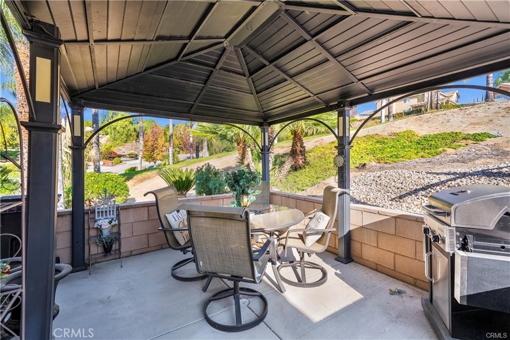 14222 Ashton Lane Riverside, CA 92508 - Photo 11 of 13 a patio with table and chairs and potted plants