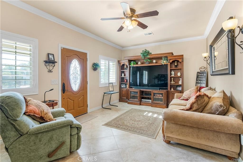 14222 Ashton Lane Riverside, CA 92508 - Photo 3 of 13 a living room with furniture and a flat screen tv