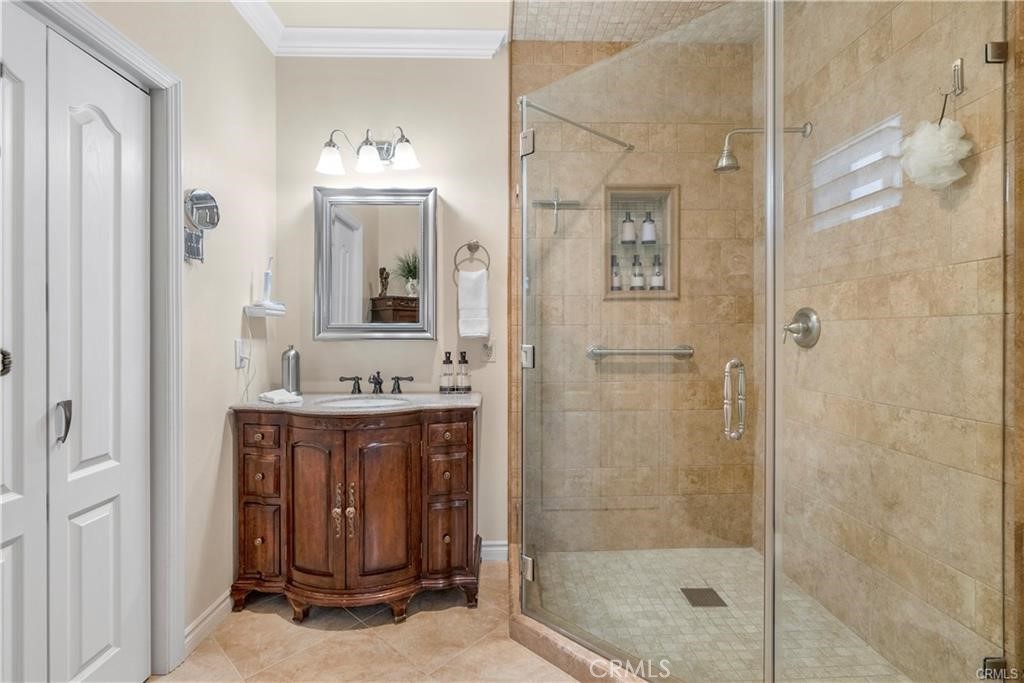 14222 Ashton Lane Riverside, CA 92508 - Photo 7 of 13 a bathroom with a sink a mirror and a shower