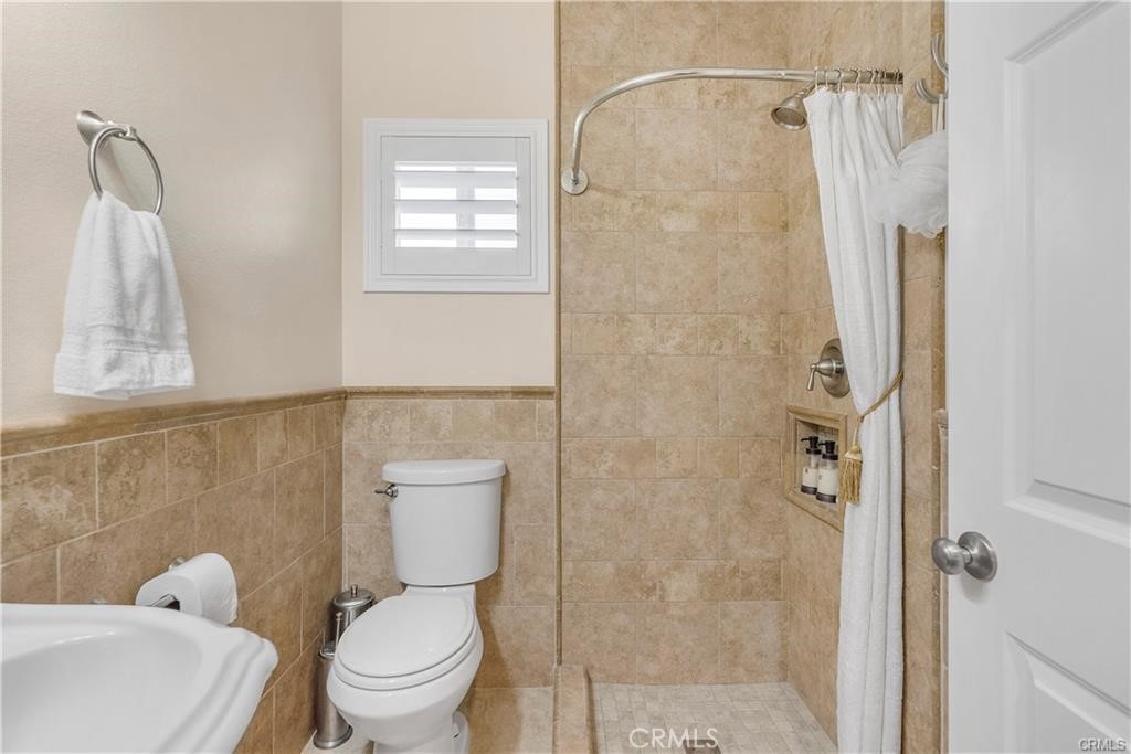 14222 Ashton Lane Riverside, CA 92508 - Photo 10 of 13 a white toilet sitting next to a bathroom sink