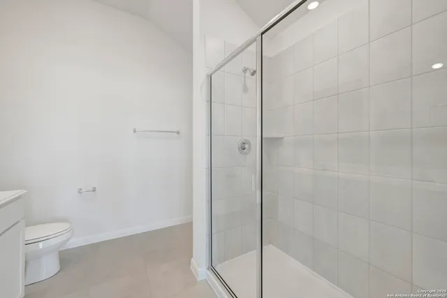 a bathroom with a shower and a toilet