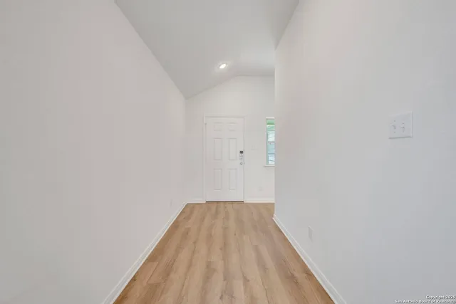 a view of hallway with wooden floor