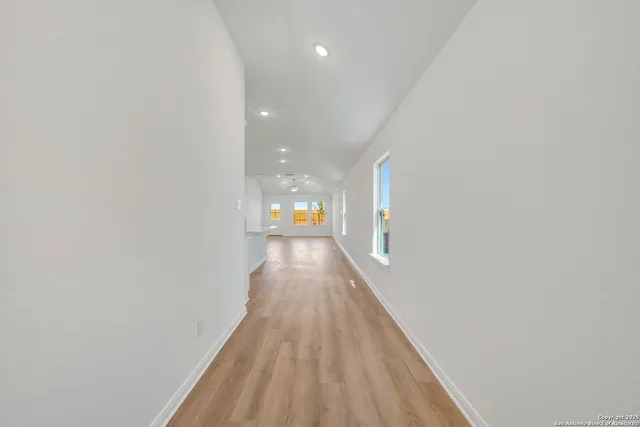 a view of a hallway with wooden floor