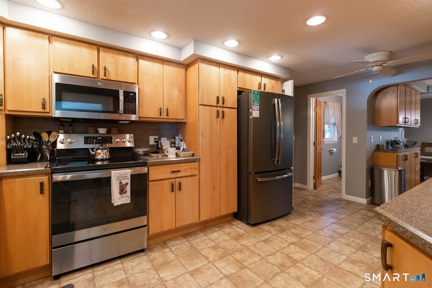763 North Street Suffield, CT 06078 - Photo 10 of 40 a kitchen with stainless steel appliances granite countertop a refrigerator microwave and sink