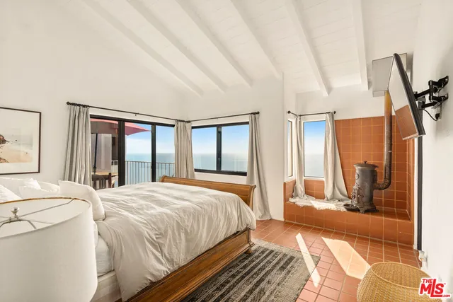 a bedroom with a large bed and a large window