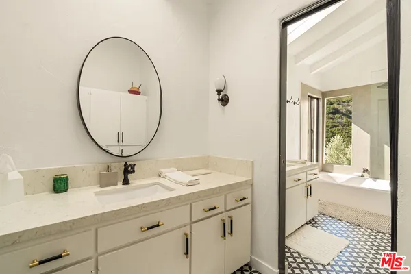 a bathroom with a sink and a mirror