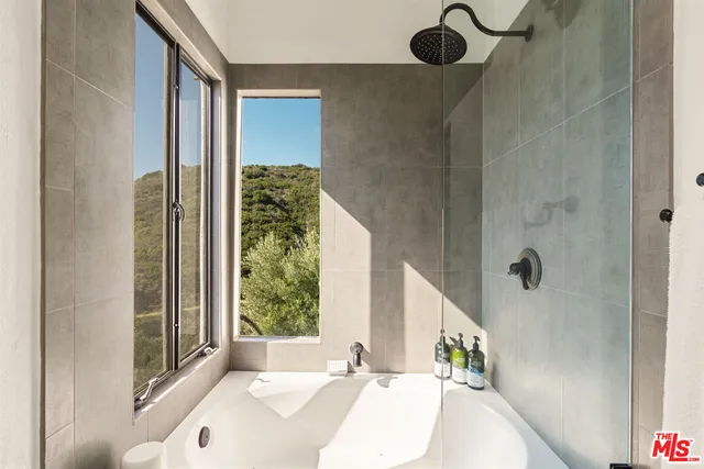 a bathroom with a granite countertop sink mirror vanity and toilet