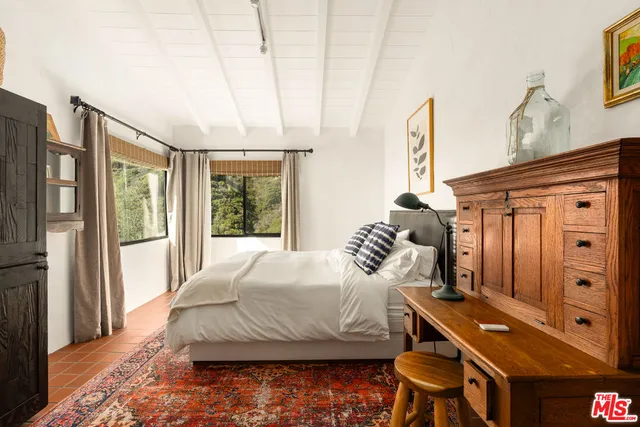 a bedroom with two beds and a large window