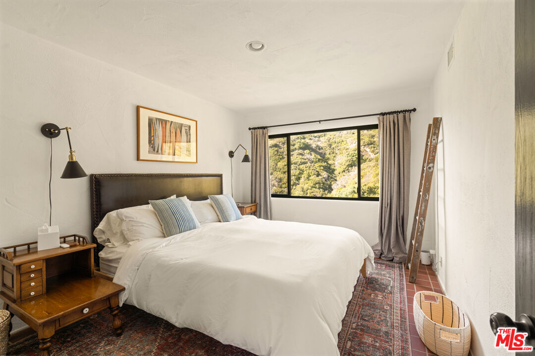 20755 Seaboard Road Malibu, CA 90265 - Photo 29 of 57 a bedroom with a bed and a window
