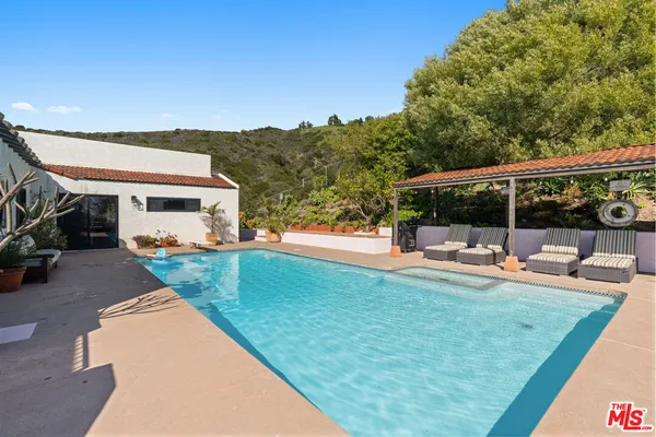 a view of a swimming pool with a patio