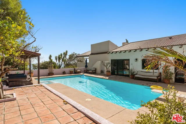 a view of swimming pool with a patio