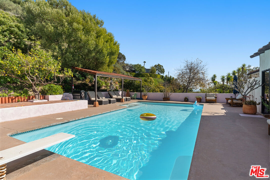 20755 Seaboard Road Malibu, CA 90265 - Photo 37 of 57 a view of a swimming pool with a patio