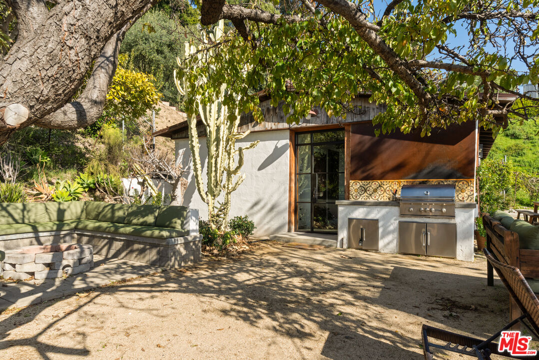 20755 Seaboard Road Malibu, CA 90265 - Photo 45 of 57 a backyard of a house with large trees