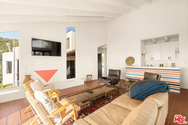 a bedroom with a bed and flat screen tv