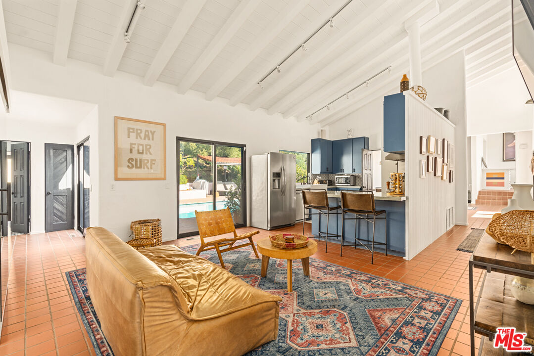 20755 Seaboard Road Malibu, CA 90265 - Photo 10 of 57 a living room with furniture fireplace and a table