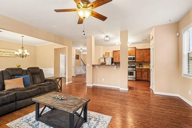a living room with furniture and kitchen view
