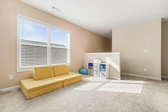 a bedroom with a bed a couch and a window