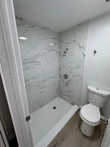 a bathroom with a toilet and shower