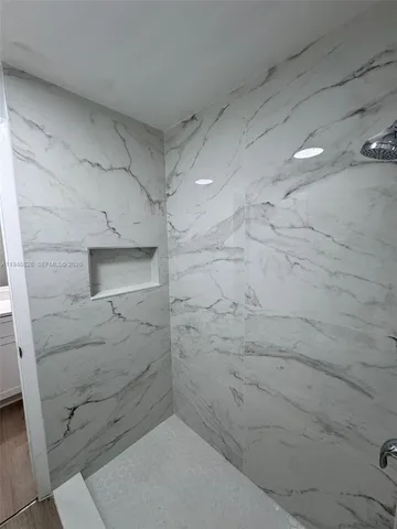 a bathroom with a shower and a sink