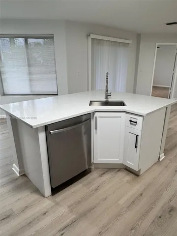 a kitchen with stainless steel appliances granite countertop a sink and a stove top oven