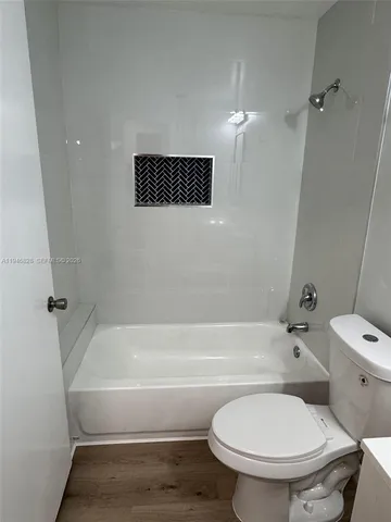a bathroom with a toilet and a tub