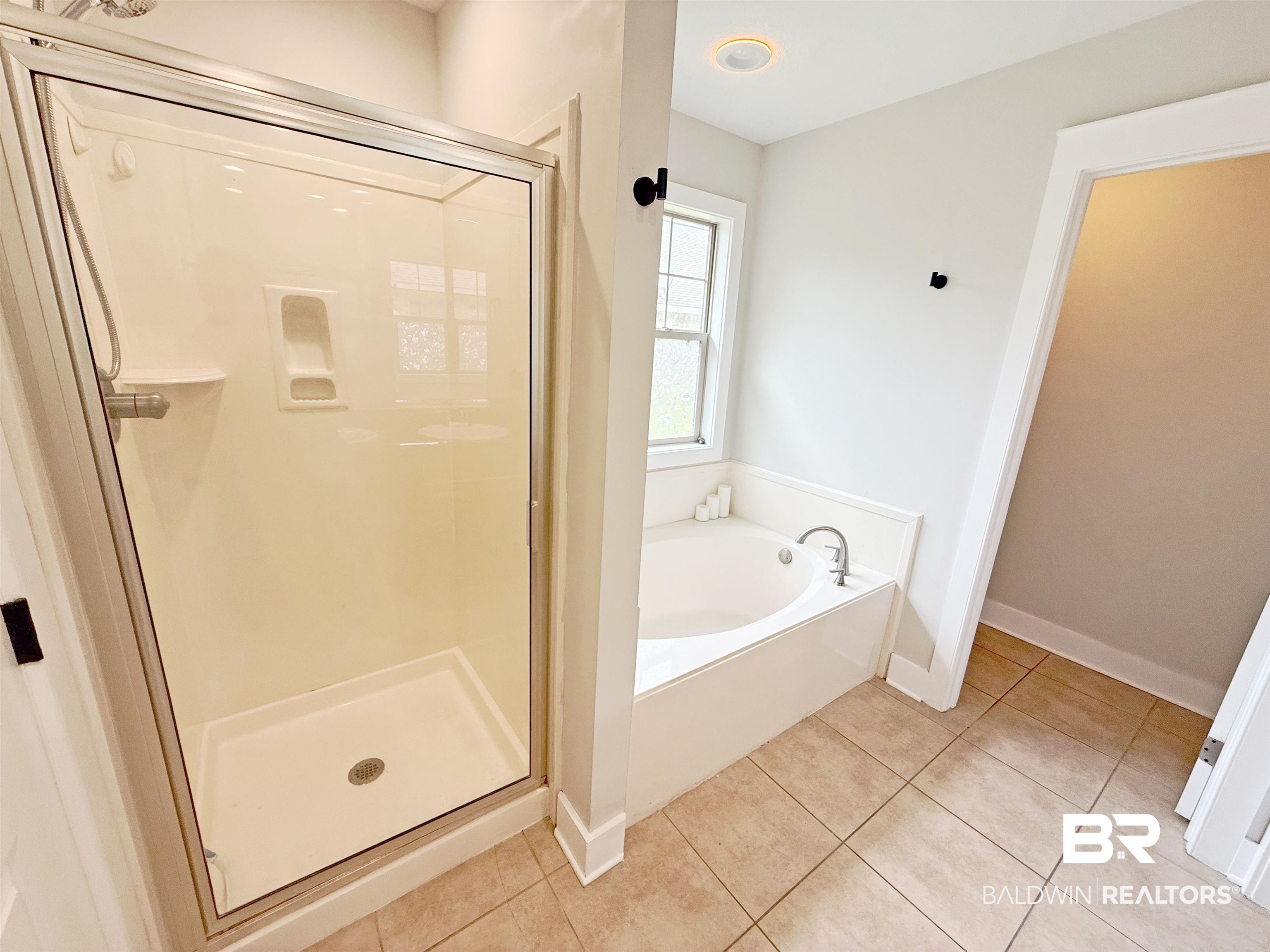 22023 Garland Loop Silverhill, AL 36576 - Photo 18 of 33 Bathroom with a shower stall, a bath, and tile patterned flooring