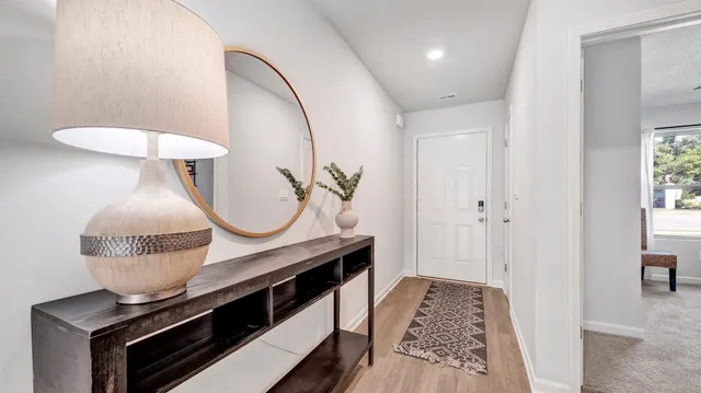 a very nice looking room with wooden floor and furniture