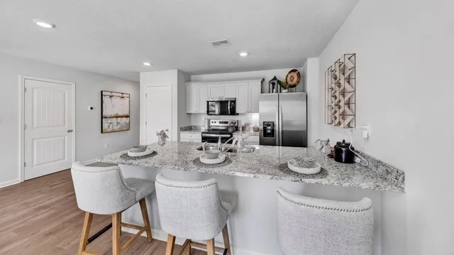 a dining room with furniture and wooden floor