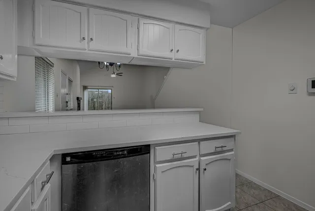 a kitchen with white cabinets and a sink