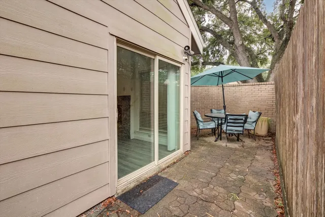 a backyard of a house with table and chairs